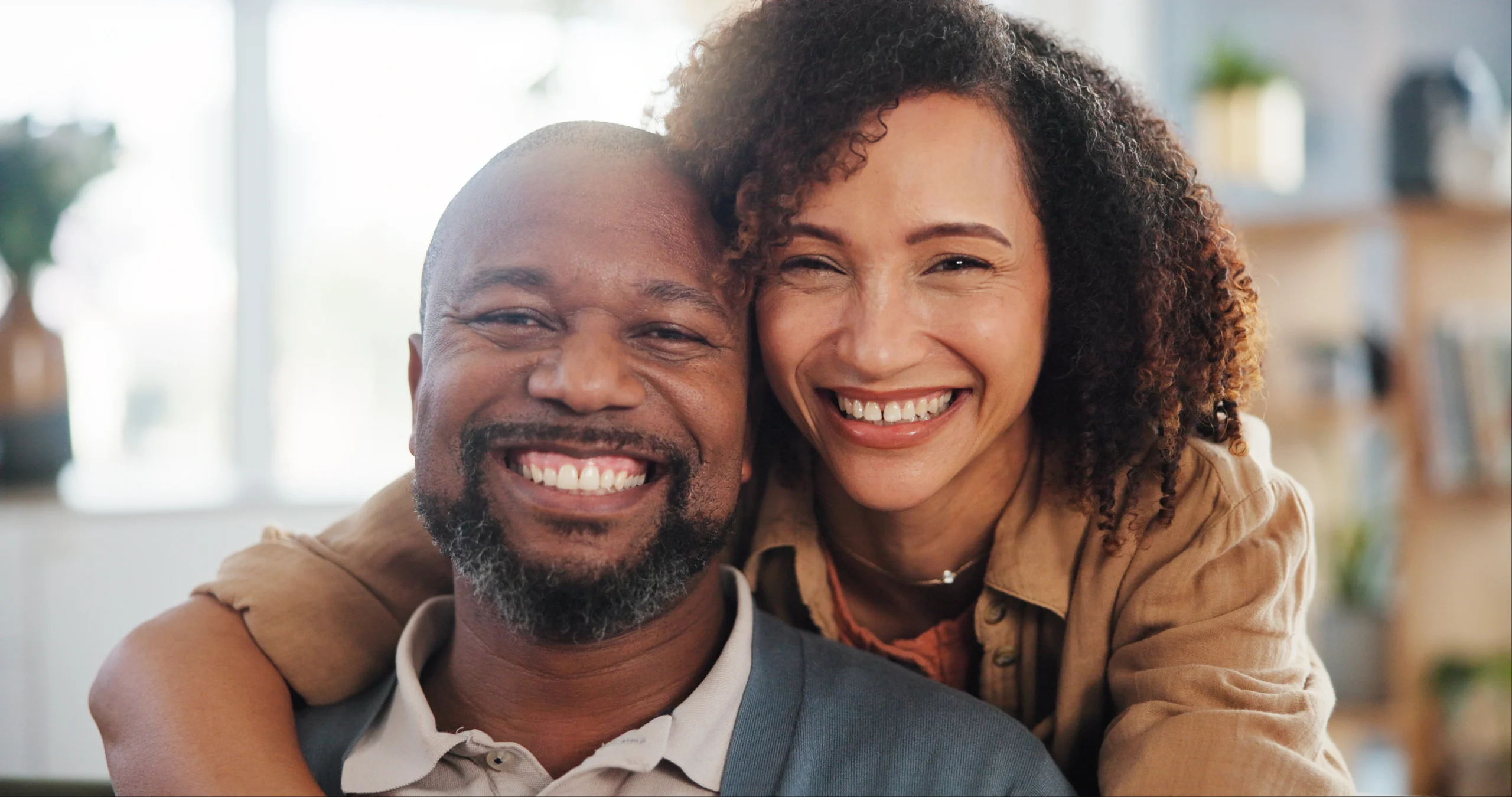 Couple smiling confidently after same-day smile treatment